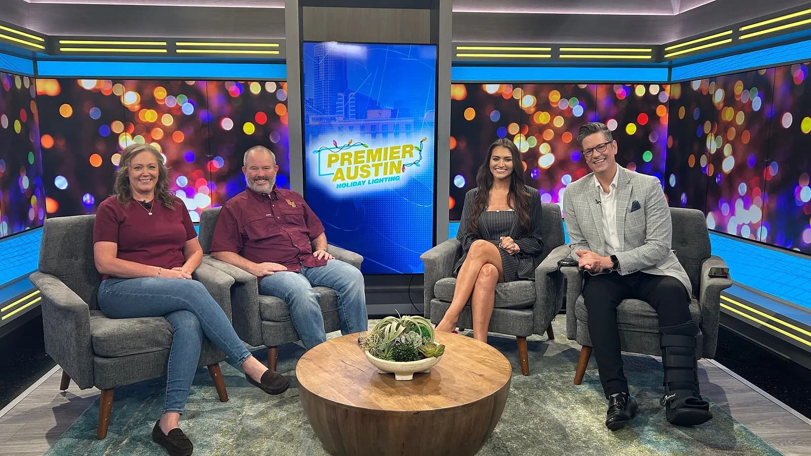 Jeff and Angie Hendricks of Premier Austin Holiday Lighting with the We Are Austin hosts on the CBS Austin set, the company logo on the screen behind them