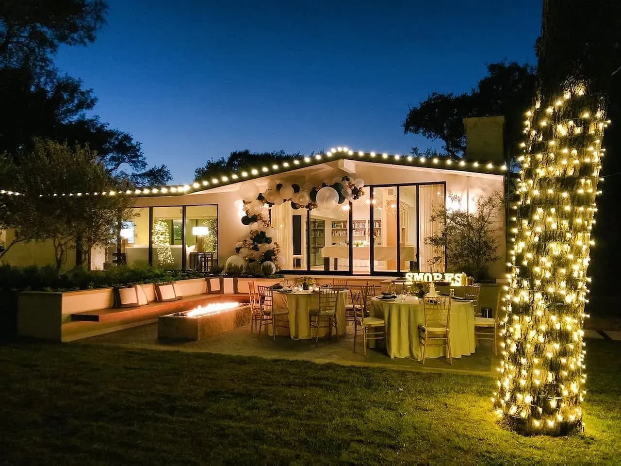 Modern home with roofline lights over the patio and a wrapped tree trunk